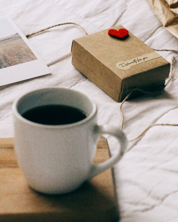 Best gifts for the coffee lover Warm scene of coffee and gift box on a cozy morning setting with a heartfelt note.