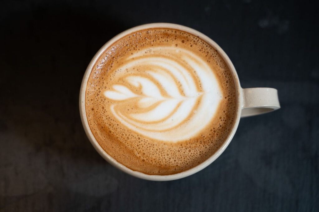 starbucks copycat recipes nespresso. Top view of a cappuccino with latte art on a dark table in a Berlin café.